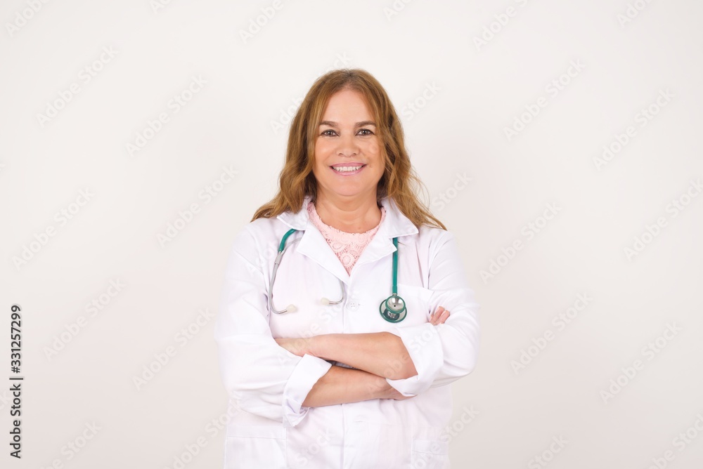 Beautiful young doctor woman wearing medical uniform with happy face smiling with crossed arms looking confident at the camera. Positive person. Beautiful young doctor woman wearing medical uniform with happy face smiling with crossed arms looking confident at the camera. Positive person.