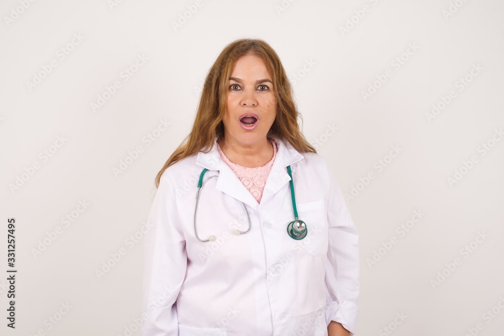 Attractive young doctor woman having stunned and shocked look, with mouth open and jaw dropped, exclaiming: Wow, I can't believe this. Surprised girl. Shock. Attractive young doctor woman having stunned and shocked look, with mouth open and jaw dropped, exclaiming: Wow, I can't believe this. Surprised girl. Shock.