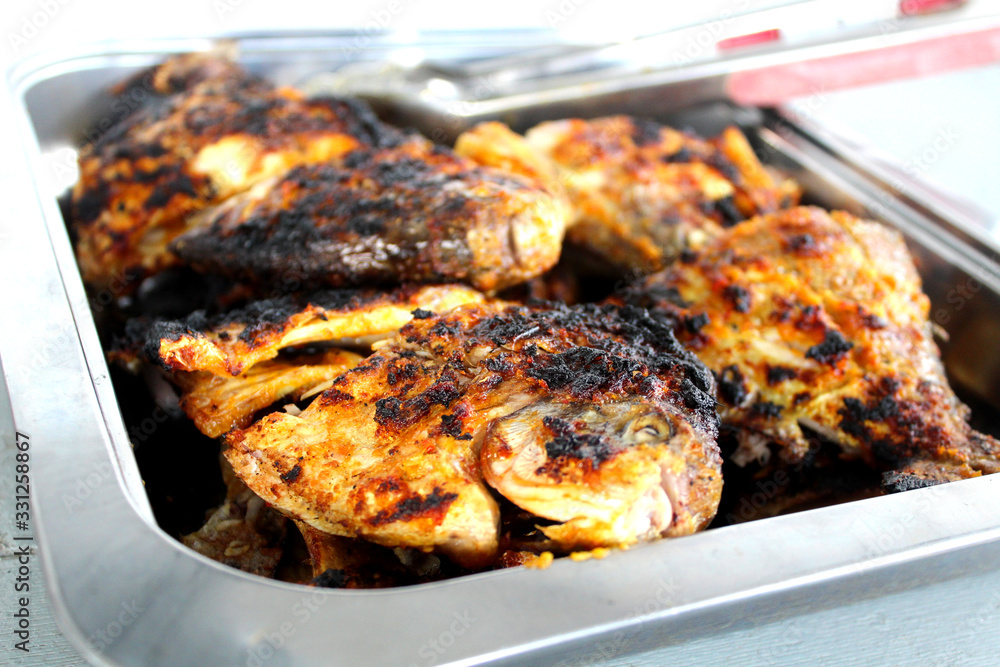 Grilled Pomfrets on a stainless-steel tray were ready to be served