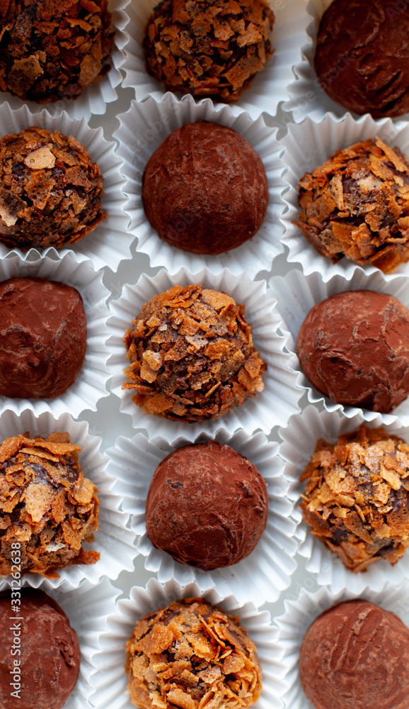 Truffle balls in paper cups inside wite paper box Truffle balls in paper cups inside wite paper box