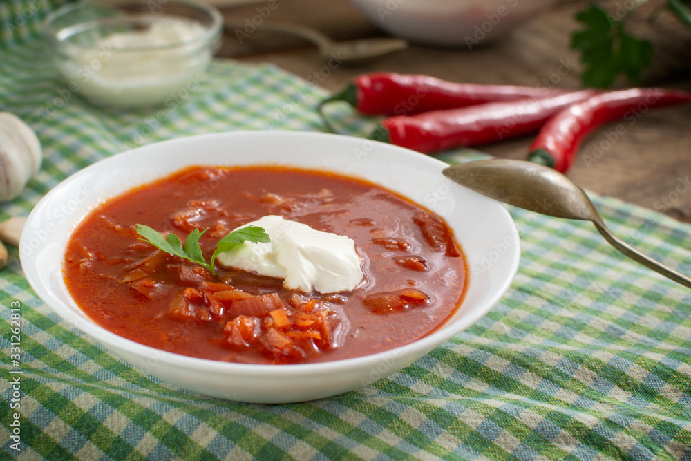 Red borsch. Ukrainian food. Rustic style. Red beetroot soup with beetroot, served with sour cream and garlic. Red borsch. Ukrainian food. Rustic style. Red beetroot soup with beetroot, served with sour cream and garlic.