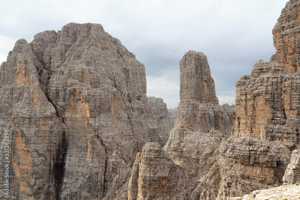Mountains Cima Brenta Alta and Campanile Basso in Brenta Dolomites with clouds, Italy
