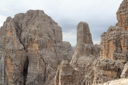 Mountains Cima Brenta Alta and Campanile Basso in Brenta Dolomites with clouds, Italy