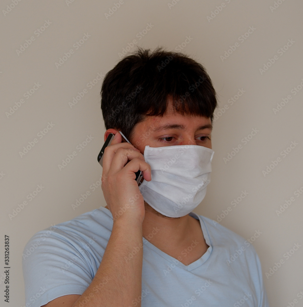 COVID-19 Pandemic Coronavirus; Man wearing face mask protective for spreading of Coronavirus Disease and talking on mobile phone. Portrait of man with surgical mask on face against SARS-CoV-2. COVID-19 Pandemic Coronavirus; Man wearing face mask protective for spreading of Coronavirus Disease and talking on mobile phone. Portrait of man with surgical mask on face against SARS-CoV-2.
