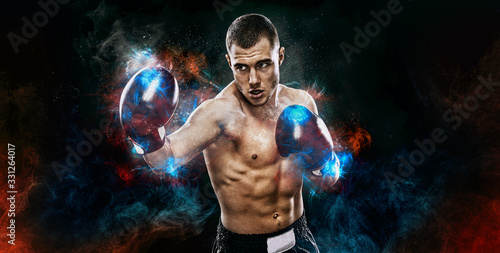 Energy and power boxing concept. Sportsman muay thai boxer fighting in gloves Isolated on black background.