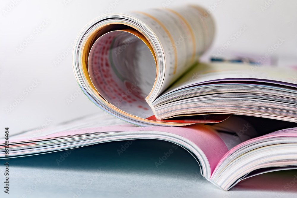 Colorful pages of an open magazine, close up. Selective focus. Colorful pages of an open magazine, close up. Selective focus.