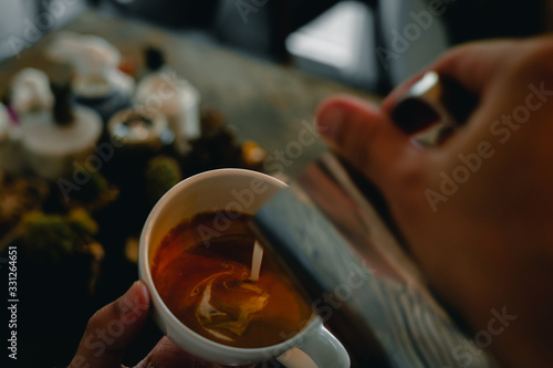 Fototapeta Barista hands holding coffee cup is making latte art