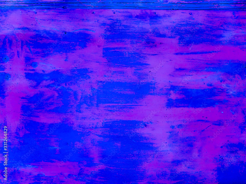 An old iron wall painted deep blue and purple