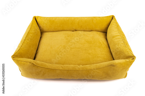 Empty yellow dog bed on a white background