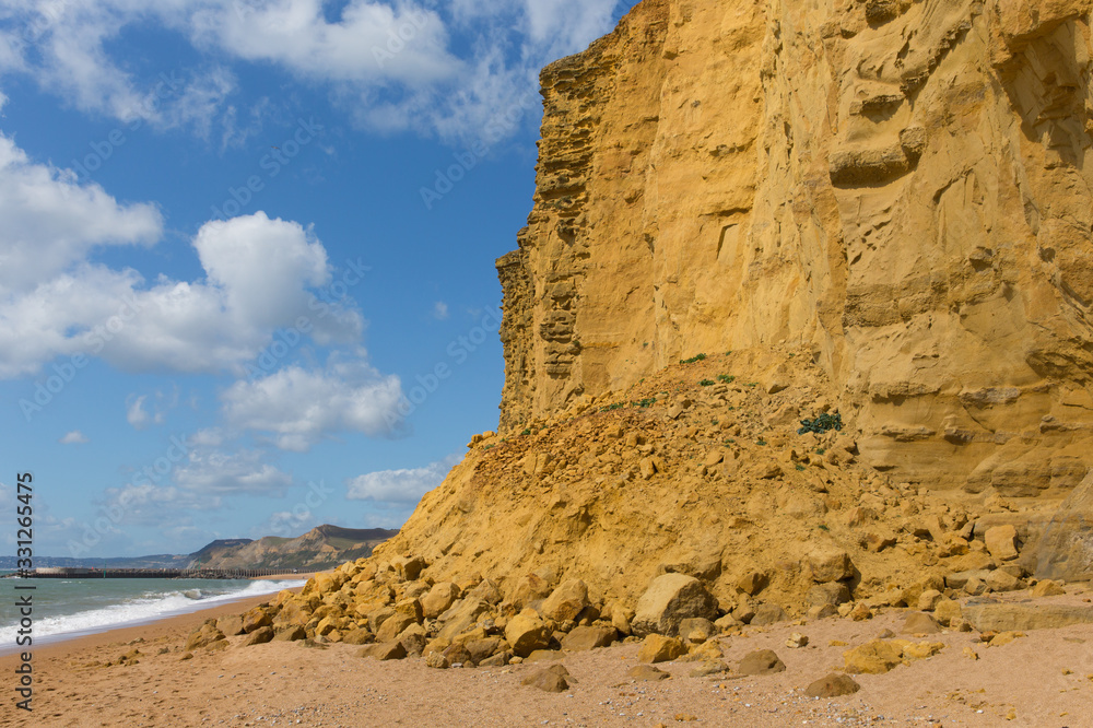 Rock fall sandstone cliff rocks Jurassic coast England UK near West Bay