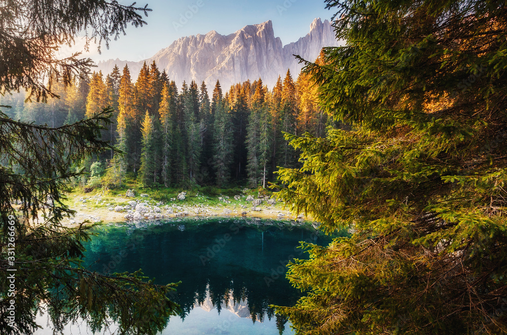 Fototapeta premium Incredible view on Lago di Carezza Karersee , a Beautiful Lake in the Dolomites alps, Italy. Amazing nature landscape.