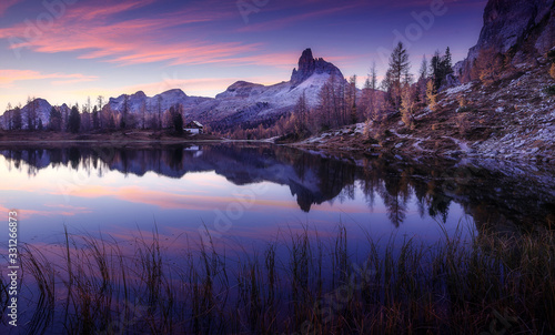 Impressively beautiful picture of wild areai dolomites alps. Fantastic Evening view on fairy tale Federa lake with colorful sky. Incredible Lago Di Federa with beautiful reflection during sunrise. photo