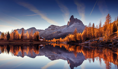 Majestic sunset of the mountains landscape. Wonderful Nature landscape during sunset. Beautiful colored trees over the Federa lake, glowing in sunlight. wonderful picturesque scene. color in nature