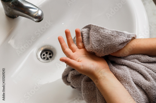 Kid washing hands rubbing soap during CoronaVirus Covid19 pandemic episode