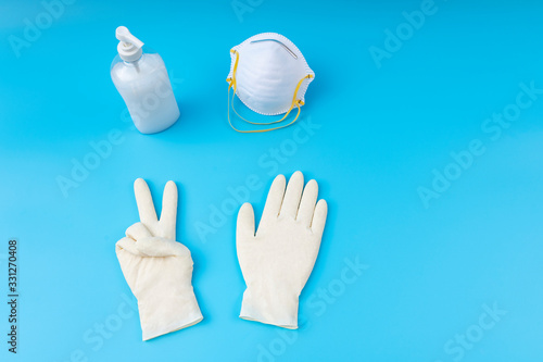 Wallpaper Mural White latex gloves,sanitizing gel and mask. Protection concept. Protection against pollution, virus, flu and coronavirus. Copy space. With proper protection you beat the virus. Torontodigital.ca