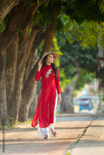 Portrait of Vietnamese girl traditional red dress,Beautiful young asian woman wearing Vietnam © background photo
