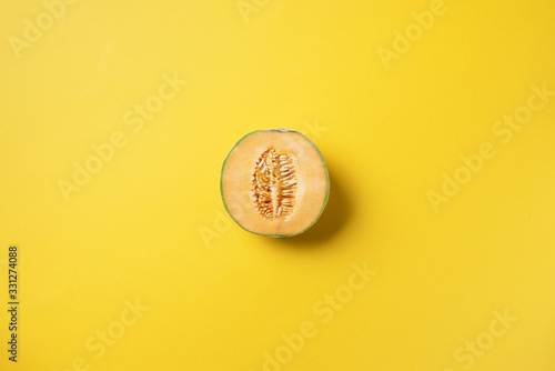 Creative layout made of melon on yellow background. Top view. Copy space. Flat lay. Food concept. Exotic cantaloupe melon fruit