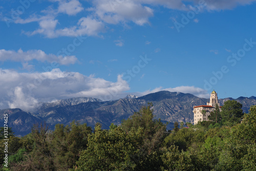 The landmark courthouse of appeals building overlooking the Arroyo Seco in Pasadena, San Gabriel Valley, and snow dusted mountains in the background.