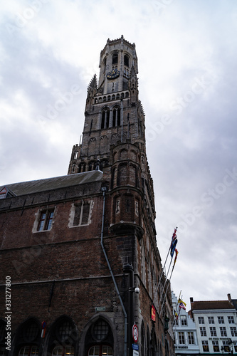 Burg Square during cloudy day, ancient building with flags and golden ornaments on the roof. photo