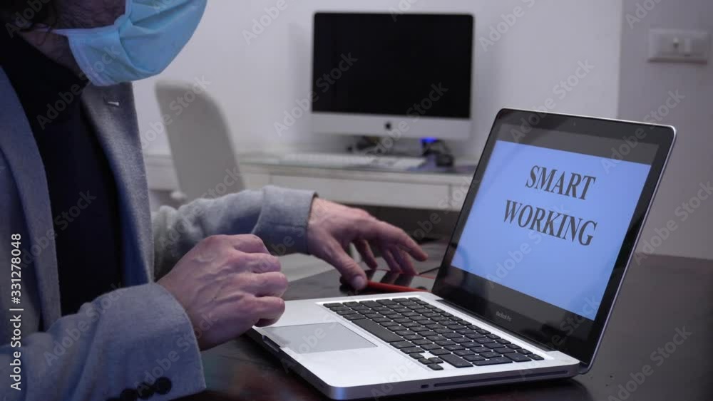 Worker in quarantine can work from home with laptop wearing and protective mask - Smart working during n-cov19 Coronavirus global epidemic Worker in quarantine can work from home with laptop wearing and protective mask - Smart working during n-cov19 Coronavirus global epidemic