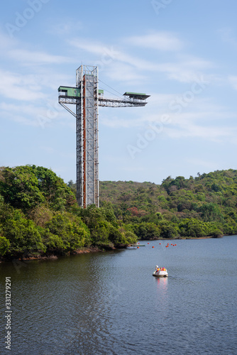 Long exposure Landscape image of Mayem Lake in Goa with the bungee jumping structure on display, Jumpin heights bungee jumping landscape view in Goa, Boat peddling in Goa photo