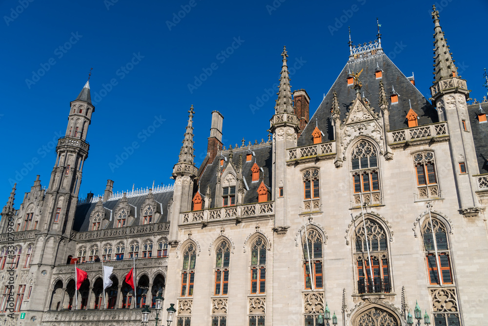 The Grote Markt, the Provinciaal Hof gothic building, and Historium building in Bruges, Belgium