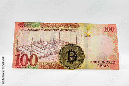 Saudi Arabian 100 Riyal bank note with Bitcoin crypto currency