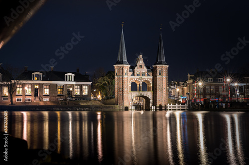 The famous historical  Waterpoort  in the city of Sneek at night with reflections in the canal - Sneek  Friesland  The Netherlands