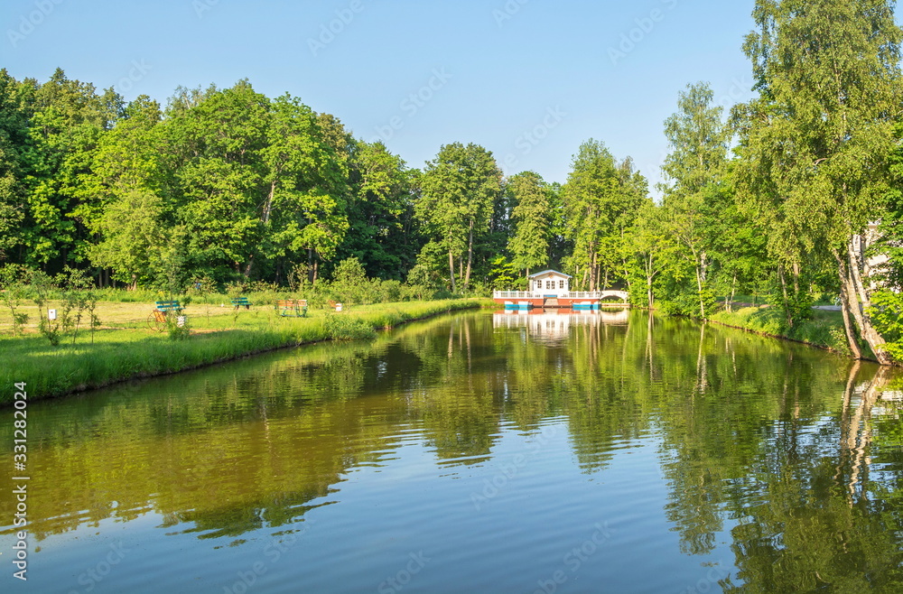 Picturesque pond in  park with  gazebo on  shore