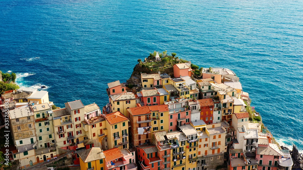 Village of Manarola in aerial view, Cinque Terre coast of Italy. Manarola is a small town in the province of La Spezia, in Liguria, in northern Italy and one of the Cinque Terre attractions 	