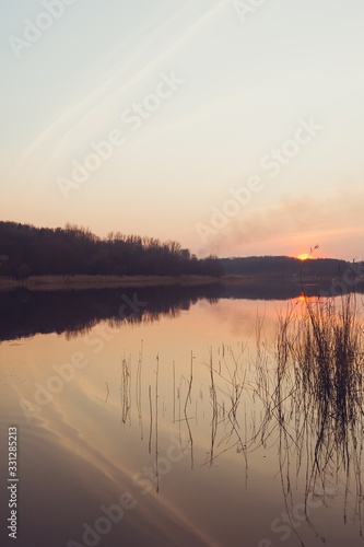 Beautiful colorful sunset over a forest lake