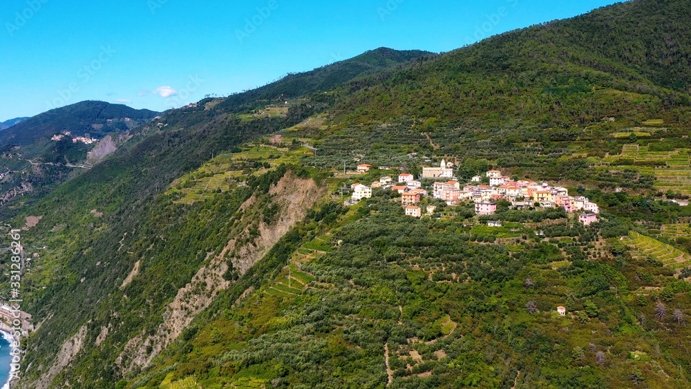 Fototapeta premium Riomaggiore Cinque Terre is a traditional and colorful fishing village near a cliff on the Mediterranean Sea, located on the Ligurian coast in Italy.