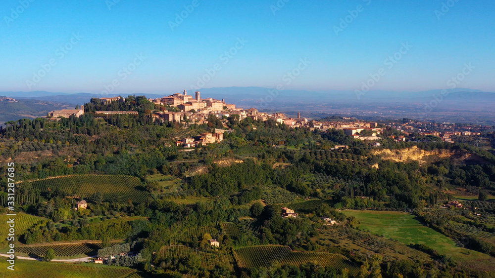 Authentic village of Montepulciano. A beautiful old town with red roofs in Tuscany, Italy. Perfect for travels and vacations - aerial view with a drone	