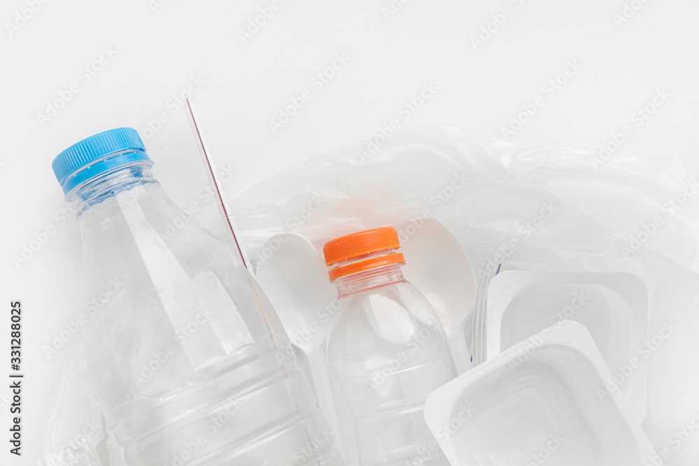top view of Plastic bottles, cocktail tube, disposable spoons, containers and bags for recycling. Concept of Recycling plastic and ecology. Plastic waste. top view of Plastic bottles, cocktail tube, disposable spoons, containers and bags for recycling. Concept of Recycling plastic and ecology. Plastic waste.
