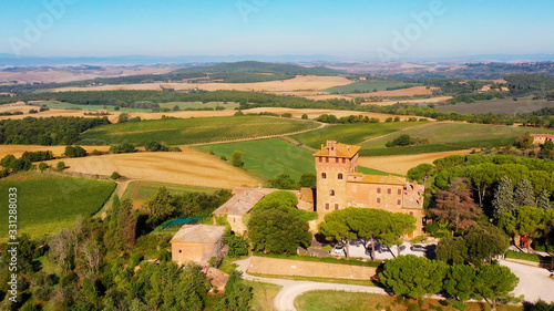 Magnificent authentic Italian villa under the sun. The house is surrounded by green meadows. Aerial view with a drone in Tuscany, Italy