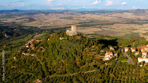 Aerial view with a drone over a magnificent authentic Italian village and green meadows. Beautiful  old village of rocca d'orcia Tuscany, Italy. Perfect for travel and vacations