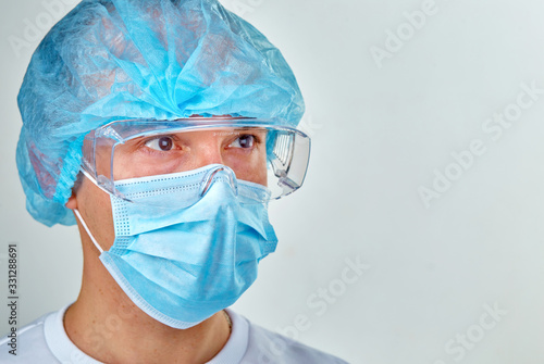 Doctor in mask is looking forward portrait