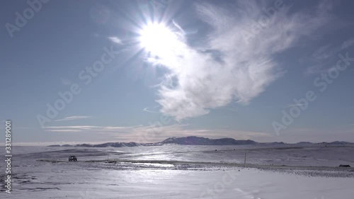 Vehicles driving on arctic road sunny winter day Iceland.mov photo