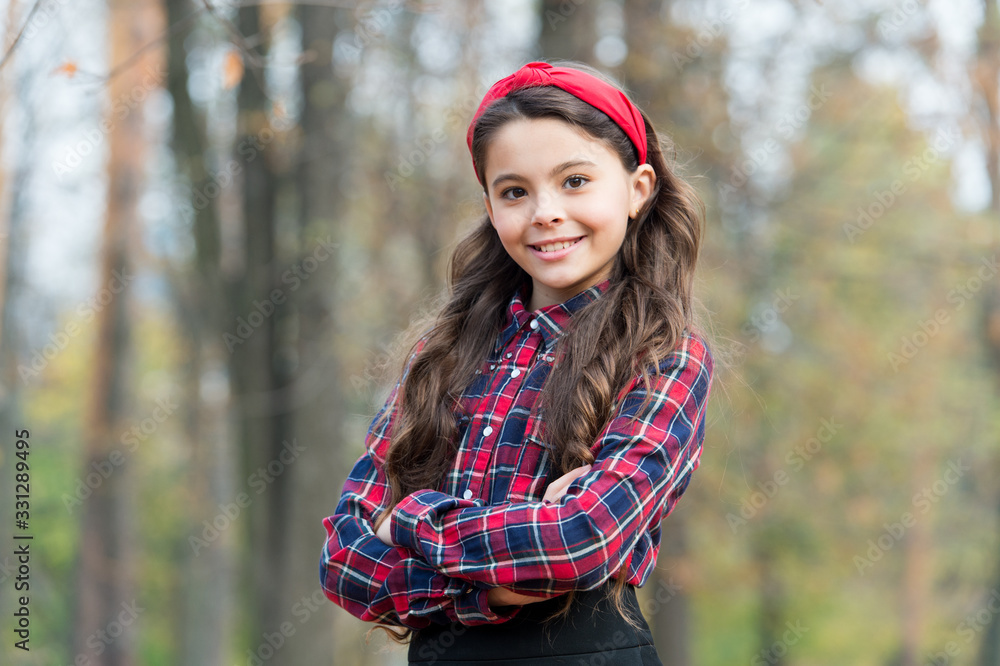Already into fashion. Happy child keep arms crossed outdoors. Fashion look of vogue model. Small girl wear school uniform. Back to school fashion. Kids wardrobe. Fashion and style Already into fashion. Happy child keep arms crossed outdoors. Fashion look of vogue model. Small girl wear school uniform. Back to school fashion. Kids wardrobe. Fashion and style