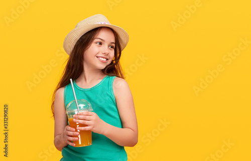 Happy young girl having refreshment with takeaway beverage and plastic straw