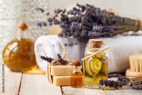 Concept of using natural organic oil in cosmetology. Moisturizing skin care and aromatherapy. Gentle body treatment. Handmade soap bars, lavender flowers. Atmosphere of harmony and relax