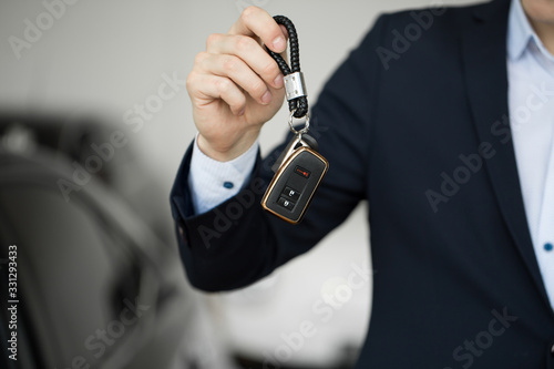 Car dealer with key close-up