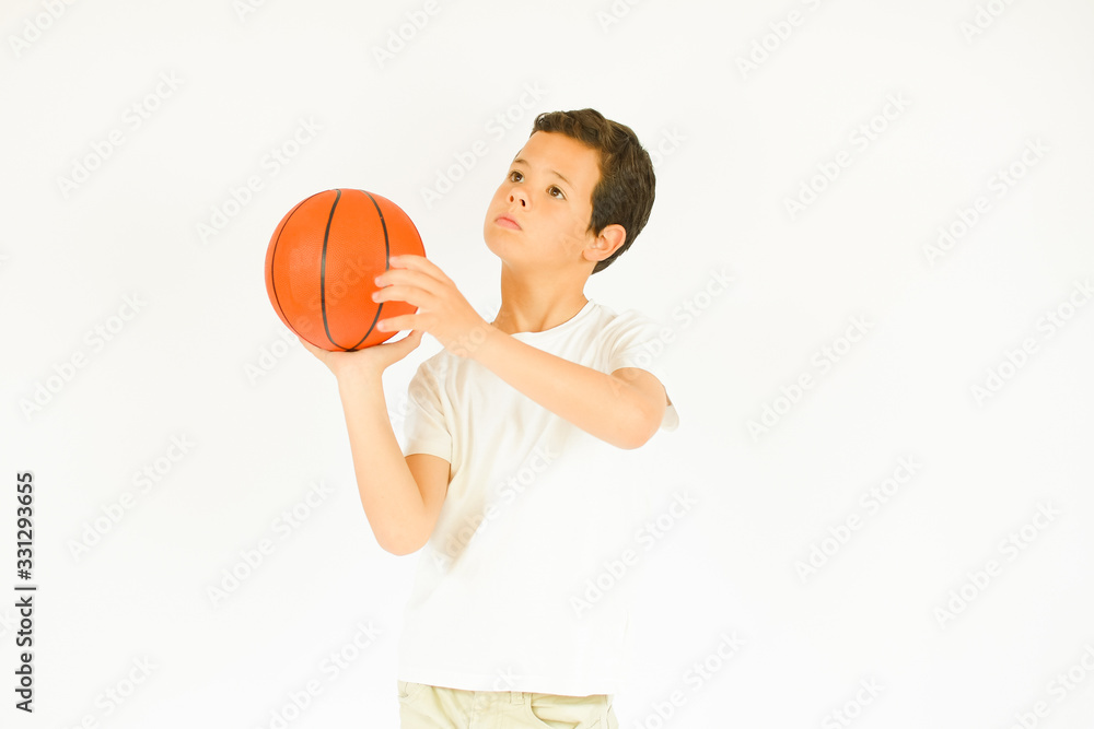 Boy in white shirt smiling with a ball