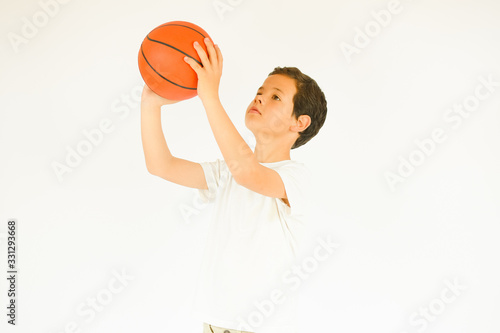 Boy in white shirt smiling with a ball