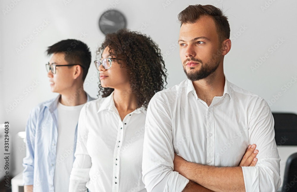 Confident diverse team looking away Confident diverse team looking away