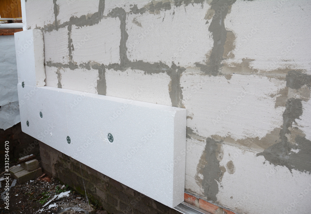 Installing rigid foam board insulation using screws with large washers