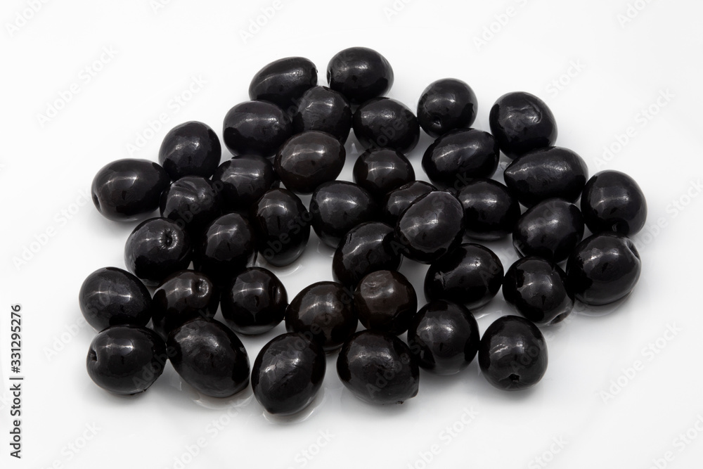 a handful of black olives on a white background