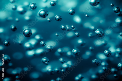oxygen and hydrogen electrolysis and boiling point. Full frame macro close up photo with selective focus in metallic blue light