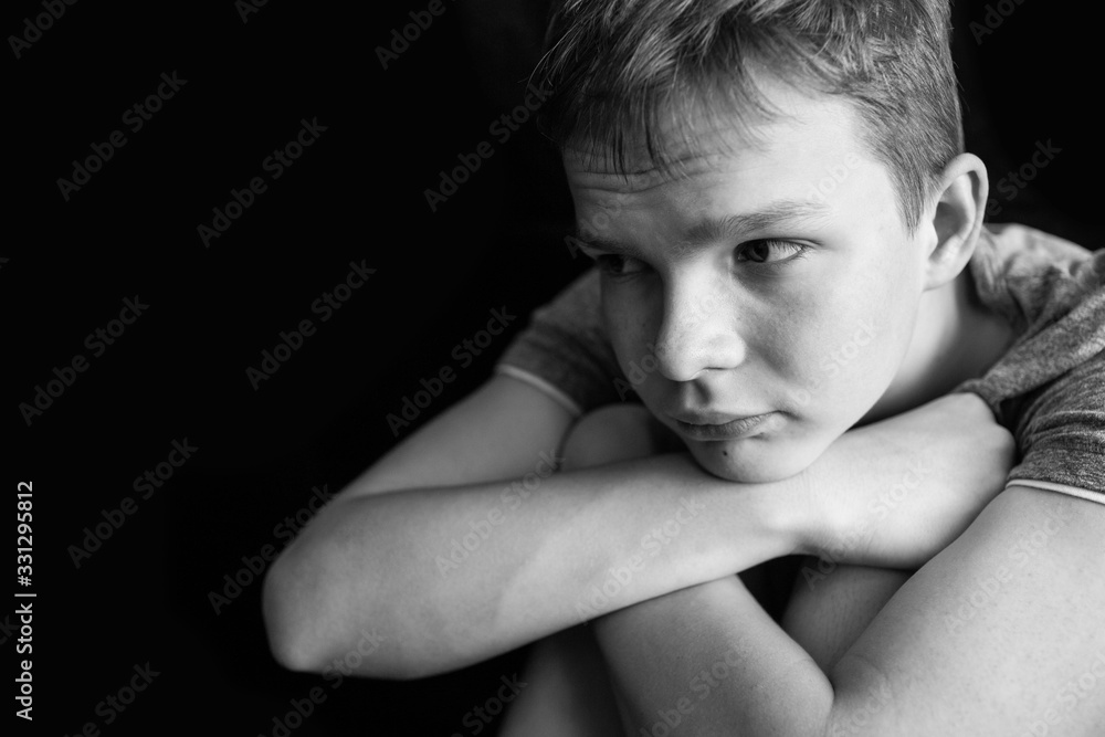 Portrait of a sad, tired, depressed teenager. Problems of teenagers, concept. Black and white photo Portrait of a sad, tired, depressed teenager. Problems of teenagers, concept. Black and white photo