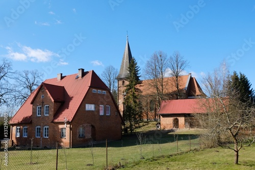 Historic brick church and presbytery in the village of Huta Kalna, Bory Tucholskie, Poland